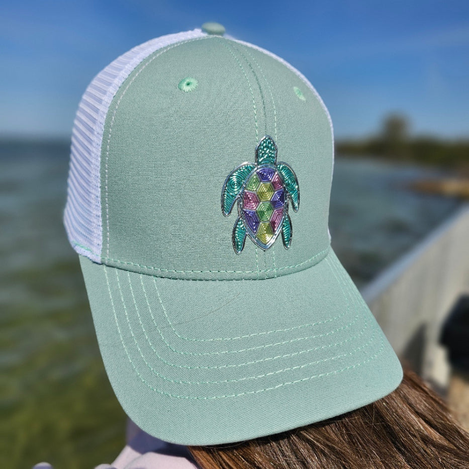 Woman wearing Loggerhead ponytail trucker hat near the water – tropical beach lifestyle