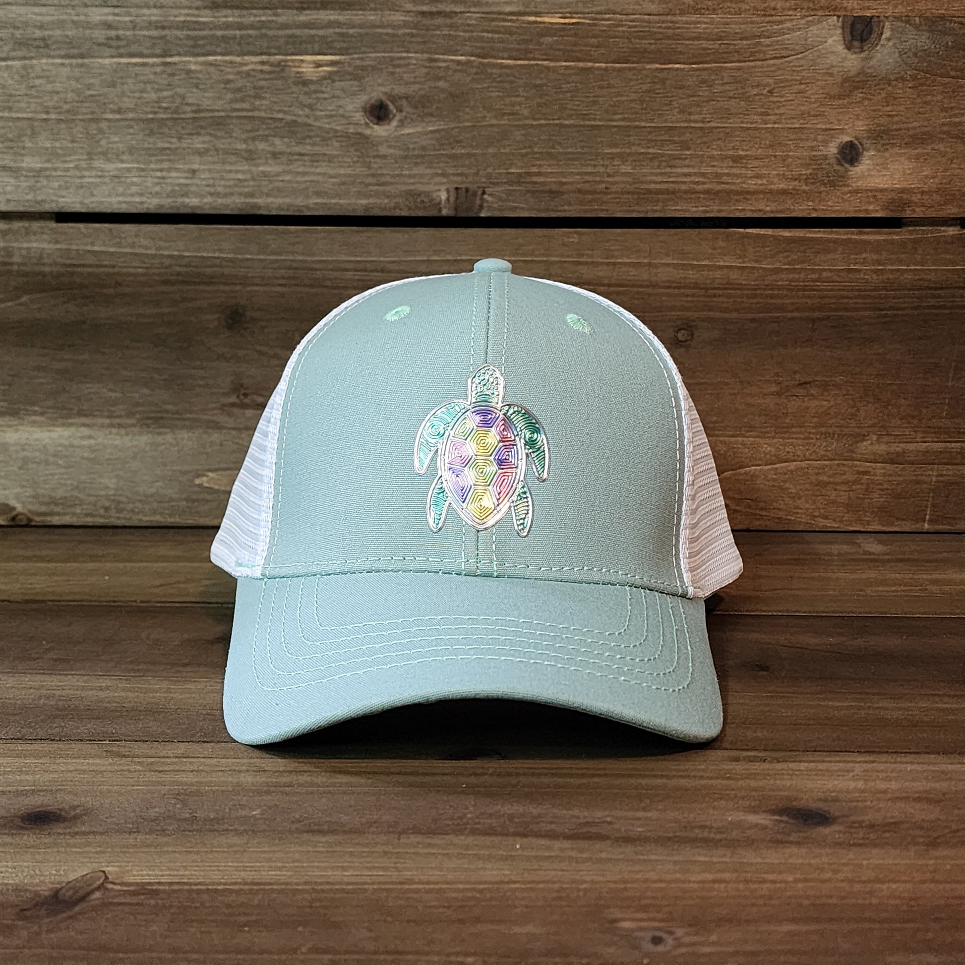 Loggerhead ponytail trucker hat with turtle patch and tropical design – front view