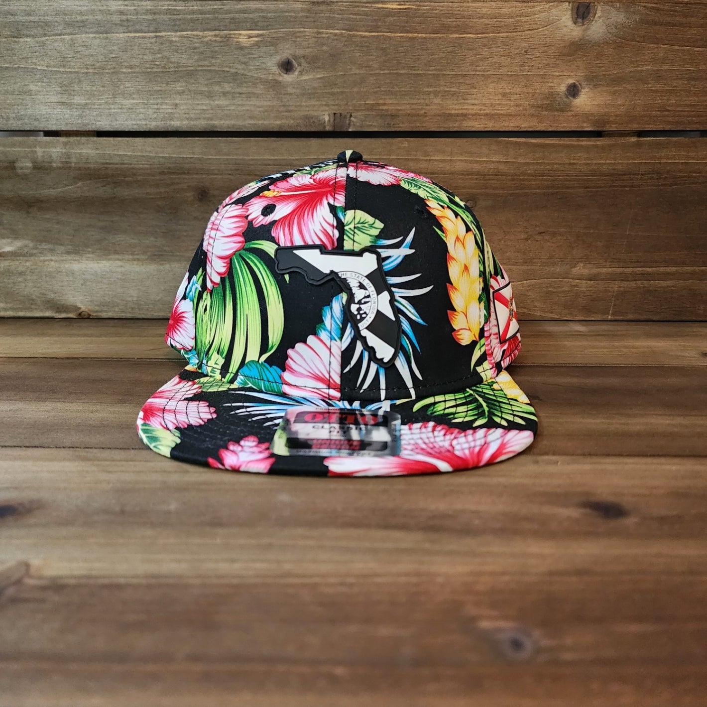 Front view of 6-panel floral snapback with 3D black Florida flag PVC patch